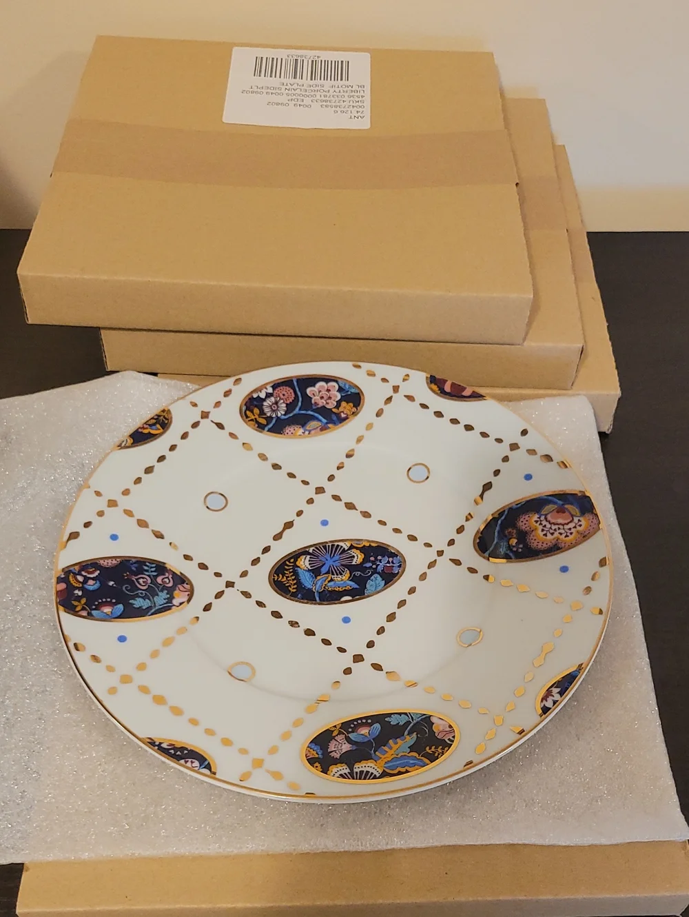 Decorative White Porcelain Plate with Blue and Gold Floral Accents